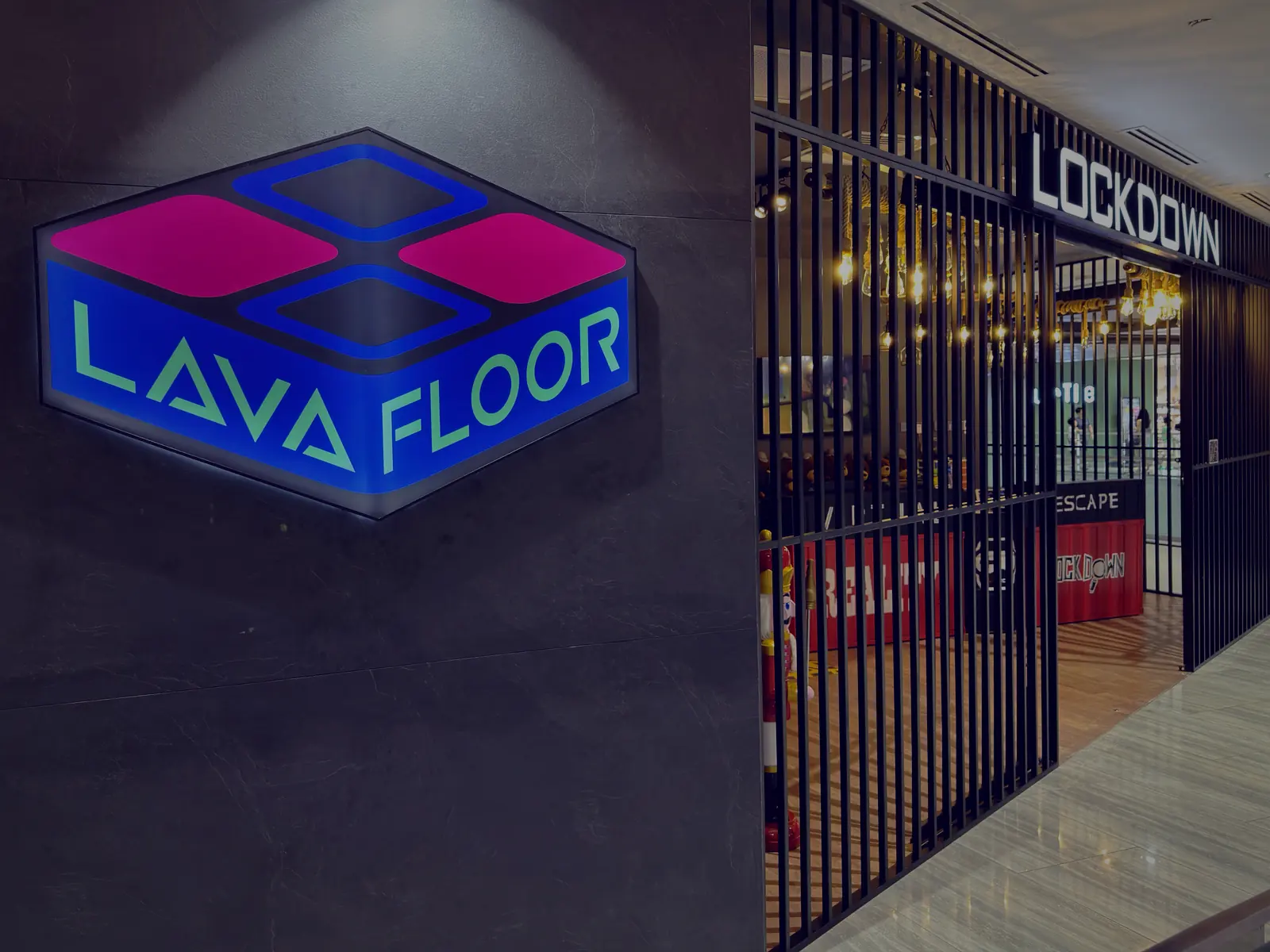 The glowing Lava Floor sign beside Lockdown's entrance at Marina Square, unit #03-149